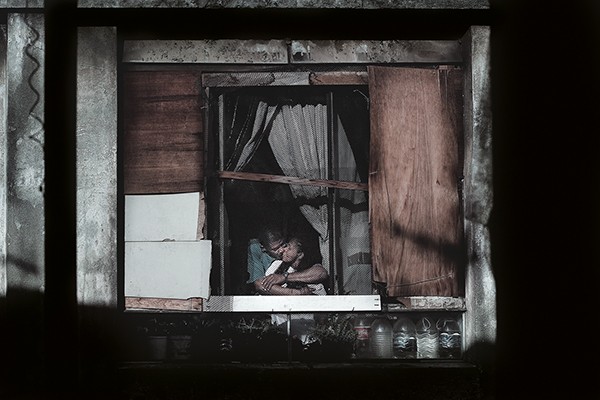 Julio Bittencourt In a Window of Prestes Maia 911 Building 